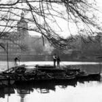 Boatmaster with boats at Belper River Gardens with the West Mill in the background.