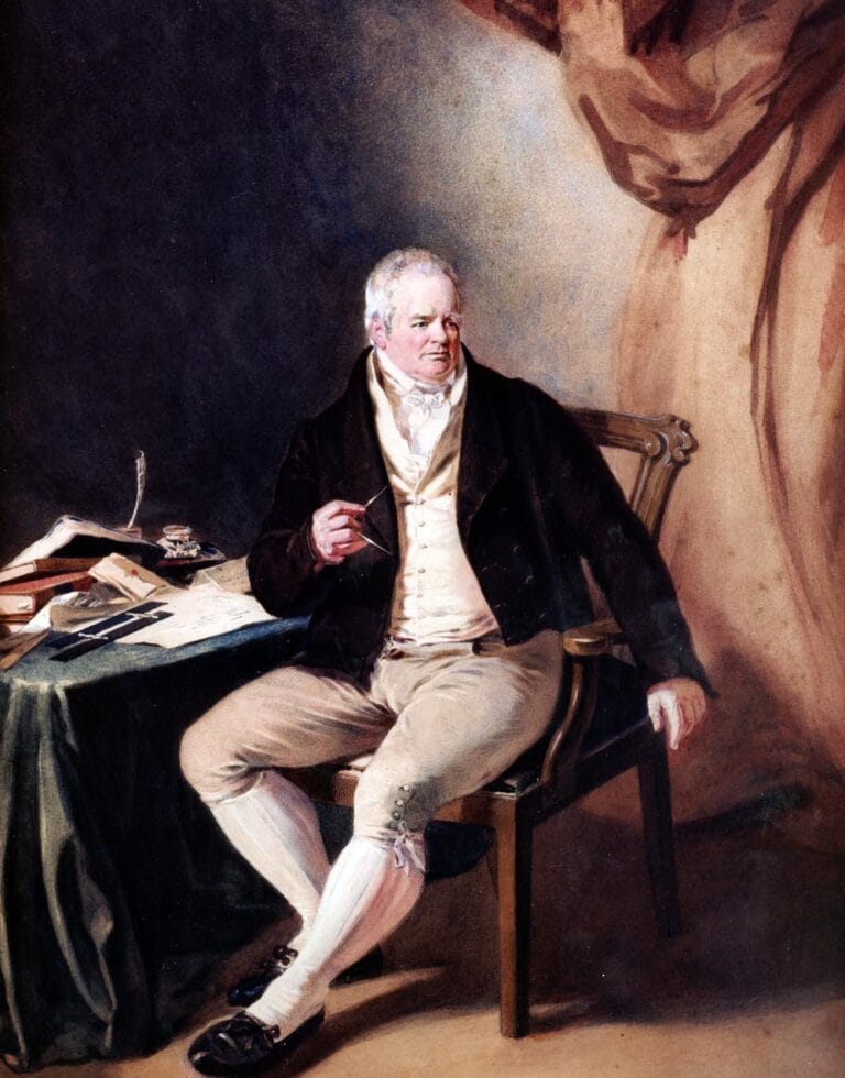 William Strutt, sat by his desk.